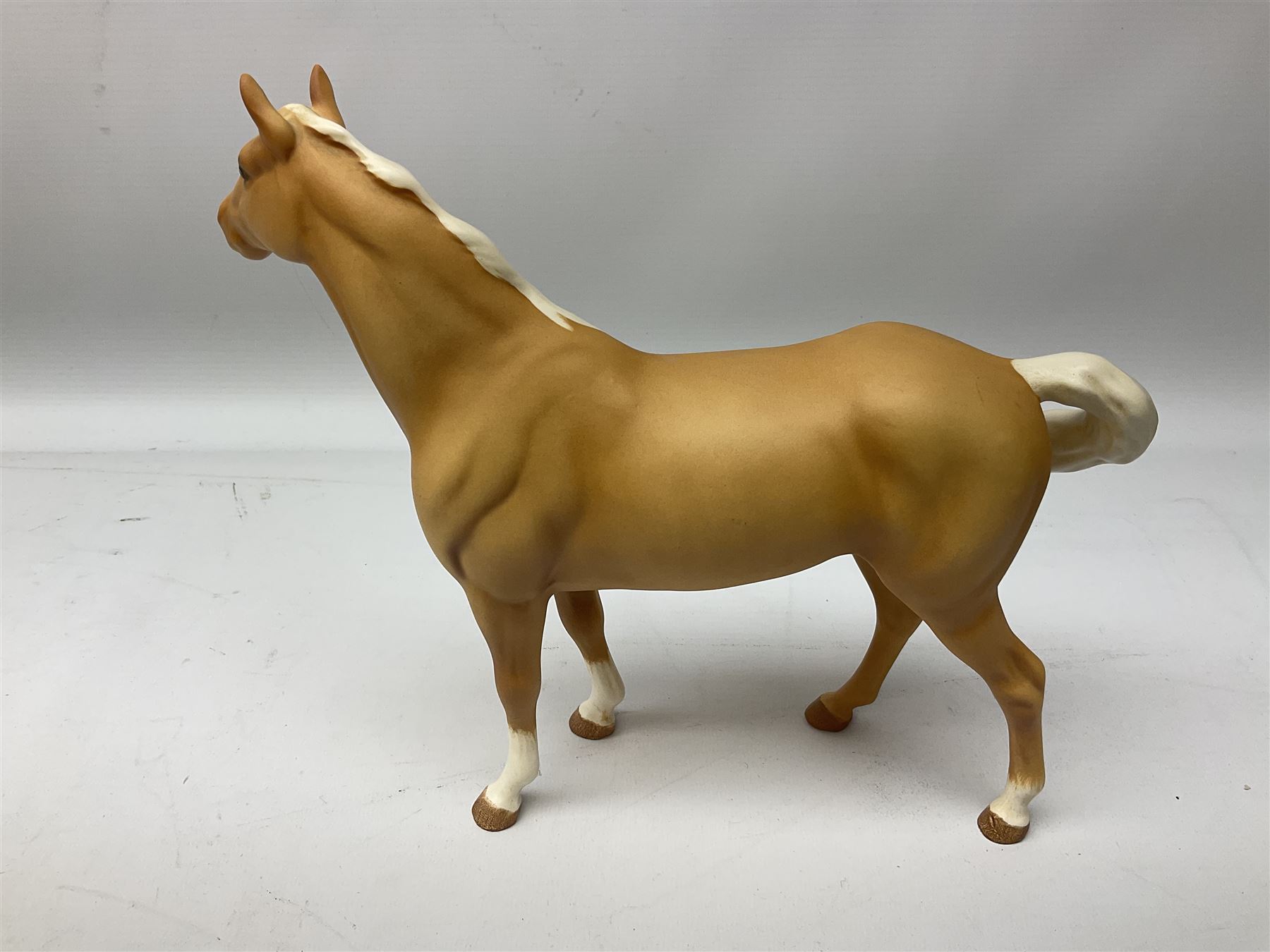 Collection of Beswick horses, including grey horse no.701, palomino foal no 836, grey stocky jogging mare no.855 etc, together two Royal Doulton horses, (8)