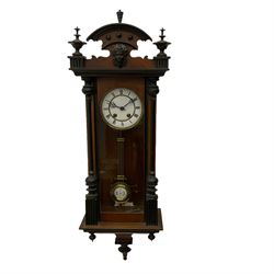 A spring driven “Vienna” regulator in a mahogany and ebonised case, with applied carving and finals, two-part enamel dial with Roman numerals and steel gothic pierced hands, 8-day Lenzkirch movement striking the hours on a gong, with visible gridiron pendulum. 
