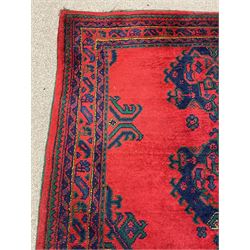 Turkish red ground rug, red ground with quadruple stylised geometric medallions, multi-band border