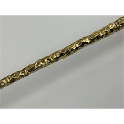 Pair of modern silver candlesticks by Stuart Devlin, the tapering parcel gilt stems with signature textured detailing, each supporting a fluted candle holder and upon a spreading circular foot, hallmarked Stuart Devlin, London 1973, H25cm