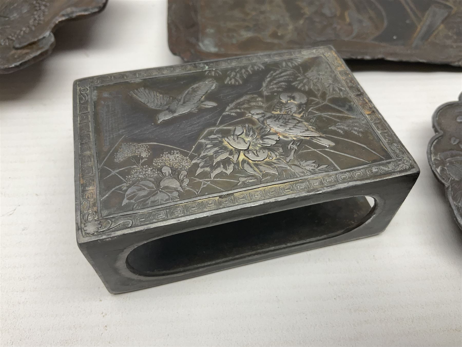 Brass sunfish ashtray, Chinese silver plated trinket box with mirror, bronzed matchbox cover and a collection of other Oriental bronzed embossed metal trays
