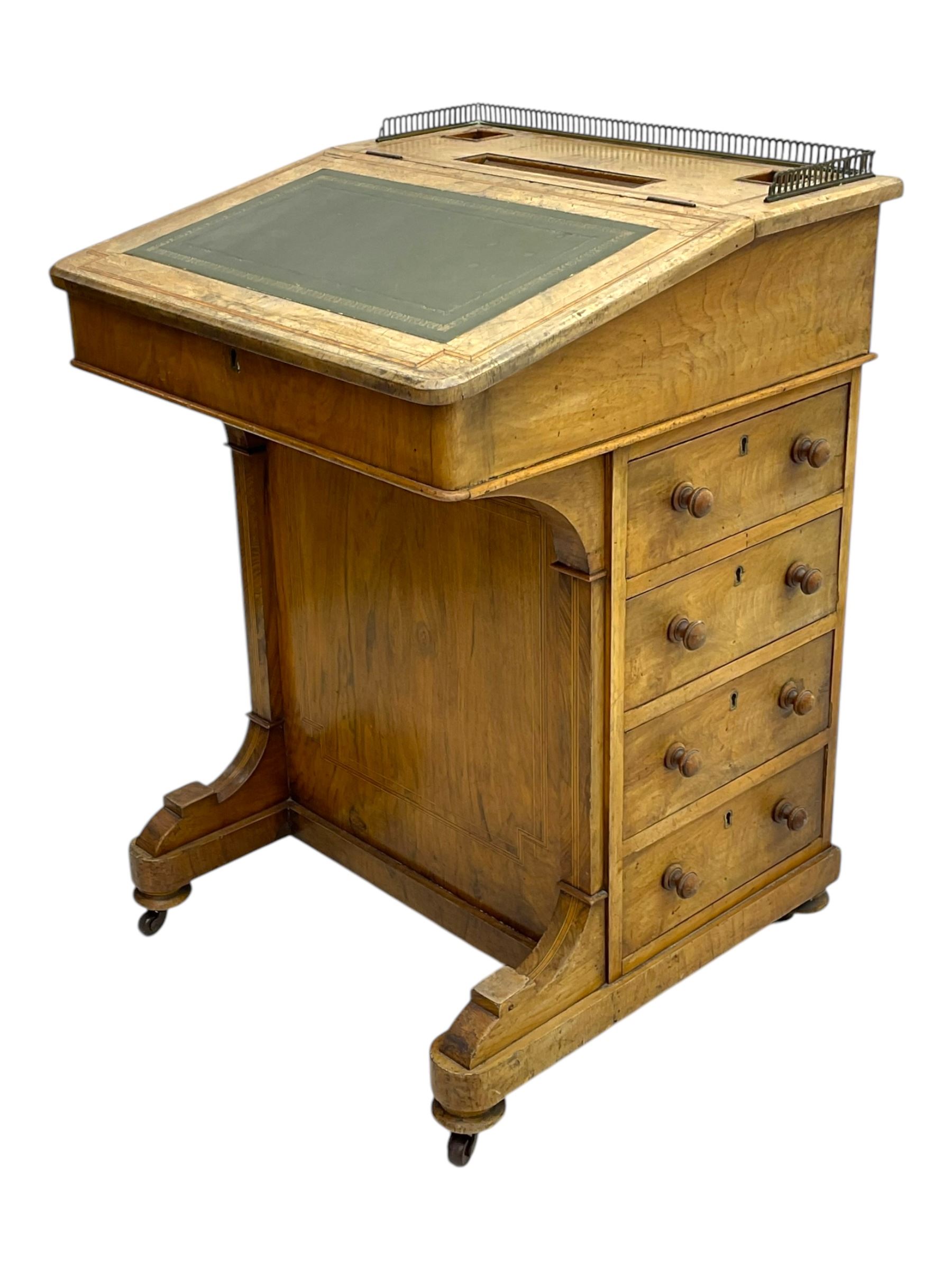 Early 19th century burr walnut Davenport desk, sloped leather-inset writing surface with brass gallery, fitted with an inkwell compartment and pen slot, four drawers to one side, raised on scrolled supports terminating in castors