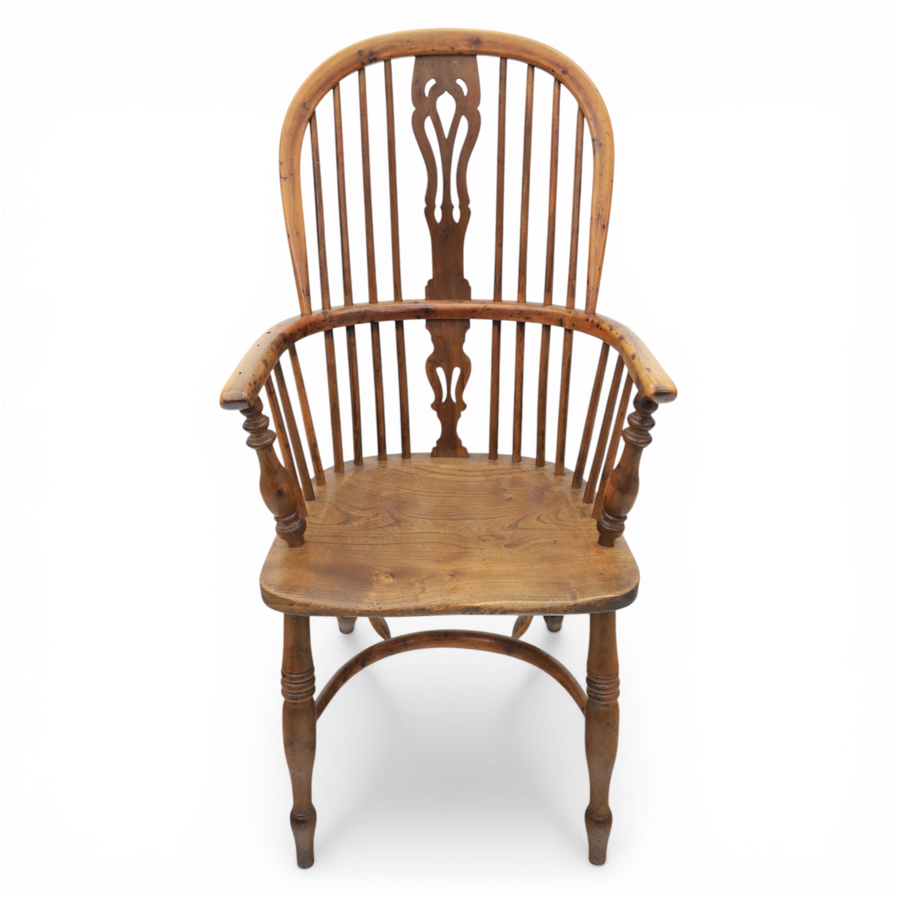 Early 20th century yew wood Windsor armchair, hooped back with spindle supports and shaped pierced central splat, solid seat with shaped edge, turned arm supports, on turned legs united by crinoline stretcher