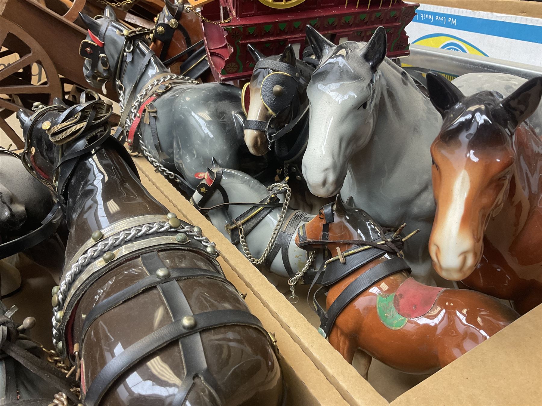 Approximately forty seven ceramic Shire horses to include Sylvac and Melba Ware examples of various sizes and colours, many with harnesses, and a quantity of carts and wagons 
