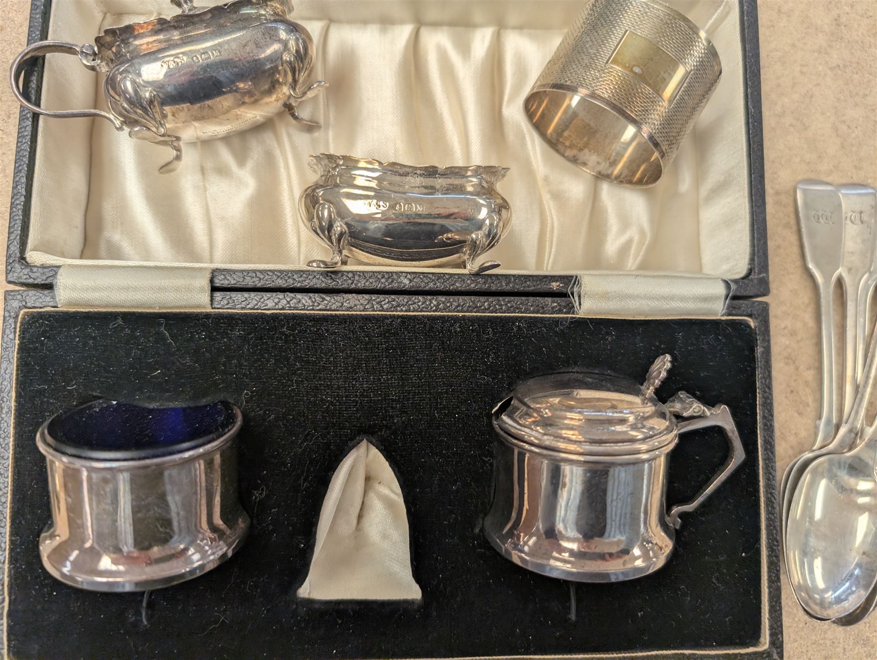 Group of silver, comprising mustard pots, open salts, napkin ring, spoons, sugar tongs and fruit knife, all stamped or hallmarked 