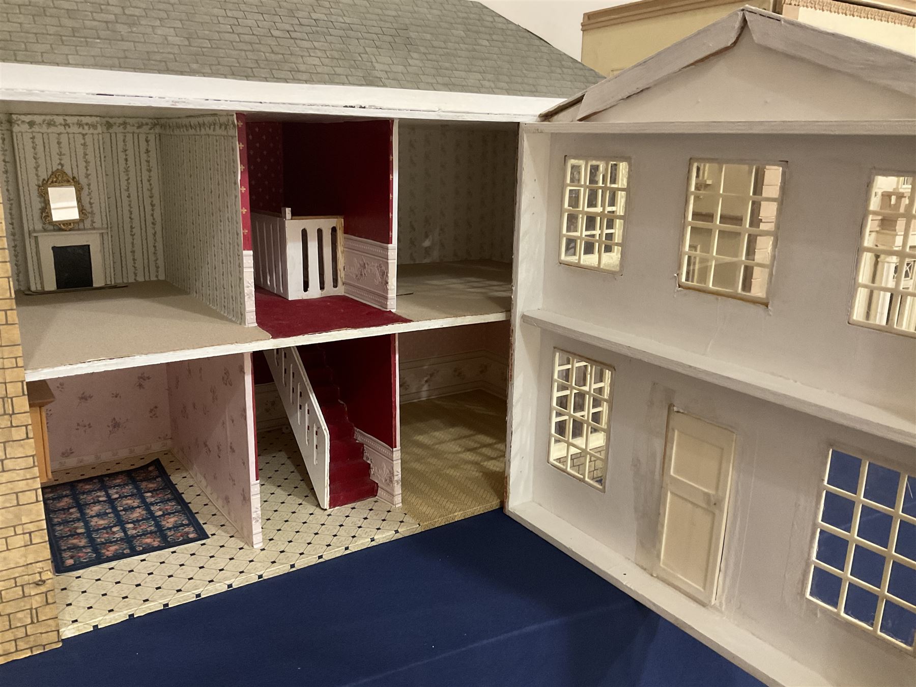Modern scratch-built Palladian style wooden dolls  house as a 19th century double fronted two-storey property with simulated brick and stone walls under a removable simulated slate hipped roof; the triple hinged front elevation opening to reveal six rooms with central hall, stairs and landing L94cm H56cm D40cm