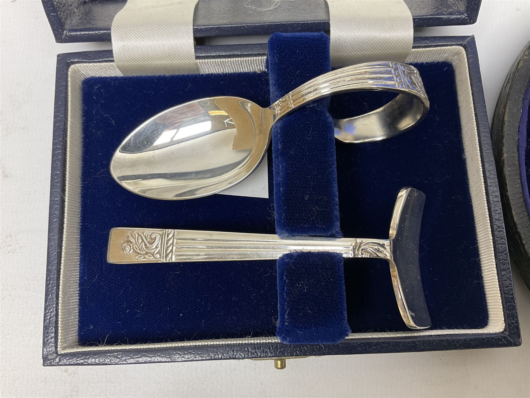 Cased pair of Wedgwood silver-plate book stands, silver-plate baby feeding spoon and pusher in box, other silver-plated cutlery