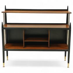 E Gomme for G Plan - 'Librenza' mid-20th century teak and ebonized wood bookcase, rectangular three-tier open shelf design with finials, narrow and raised top shelf above full span and depth central shelf, above divided shelf with open pigeonholes, sides with brass rods, raised on tapering legs with brass capped feet