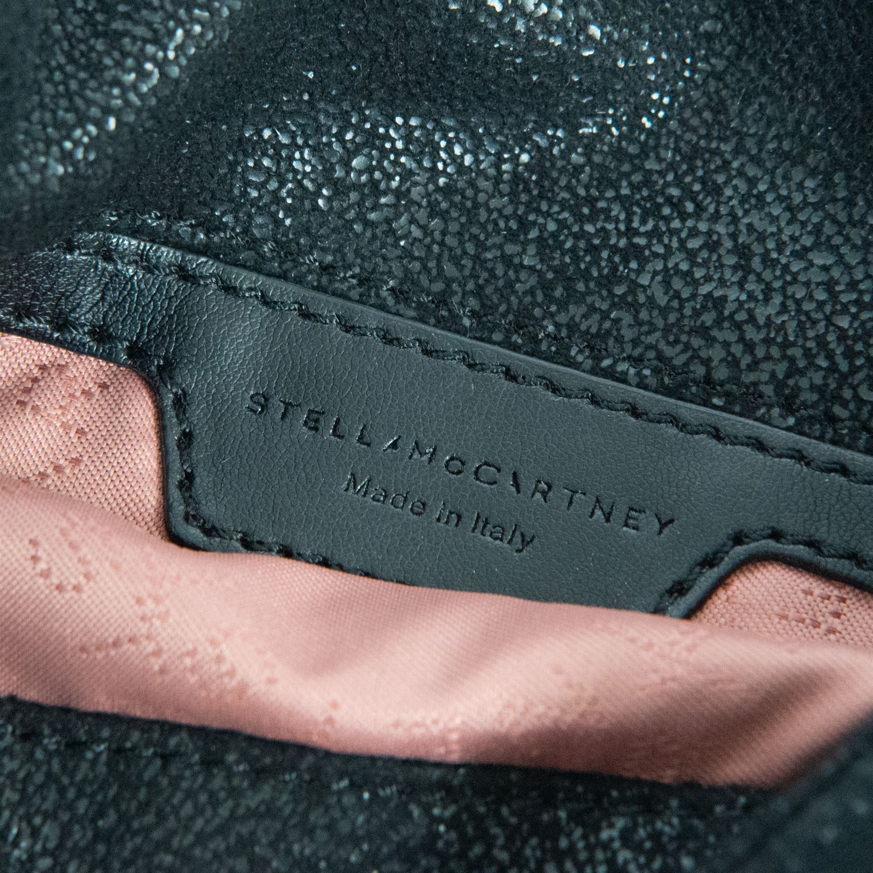Stella McCartney Falabella black shaggy deer cross-body bag, the compact foldover design with signature silver-tone curb chain trim and chain strap, logo disc charm and pink logo lining, stamped Stella McCartney Made in Italy, with dust bag