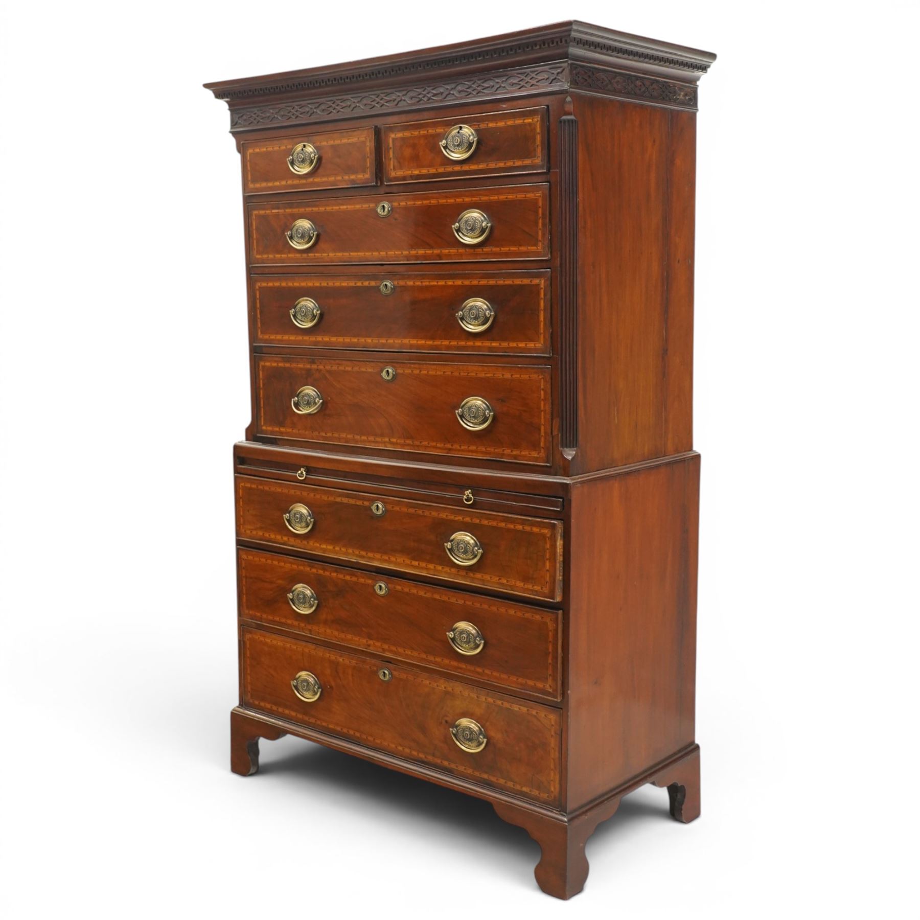  Late 18th century mahogany and inlaid chest on chest, projecting cornice above blind fretwork in laid drawers, the upper chest with two short over three graduating drawers, the lower section with brushing slide over three long graduated drawers, raised on bracket feet