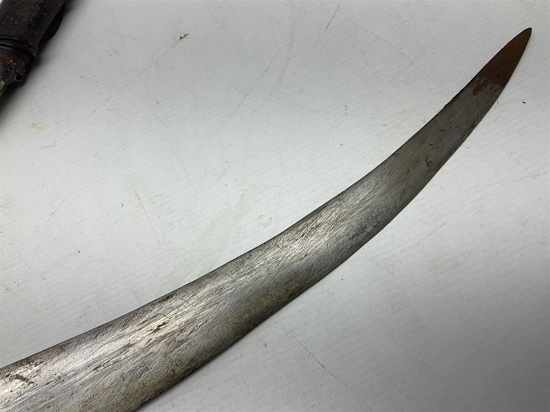 Late 19th/20th century Middle Eastern jambiya dagger the 36cm broad curved double edged steel blade with traces of script, horn and copper backed waisted white metal hilt with three roundel buttons; in ornate white metal and leather mounted brass and steel scabbard L60.5cm overall