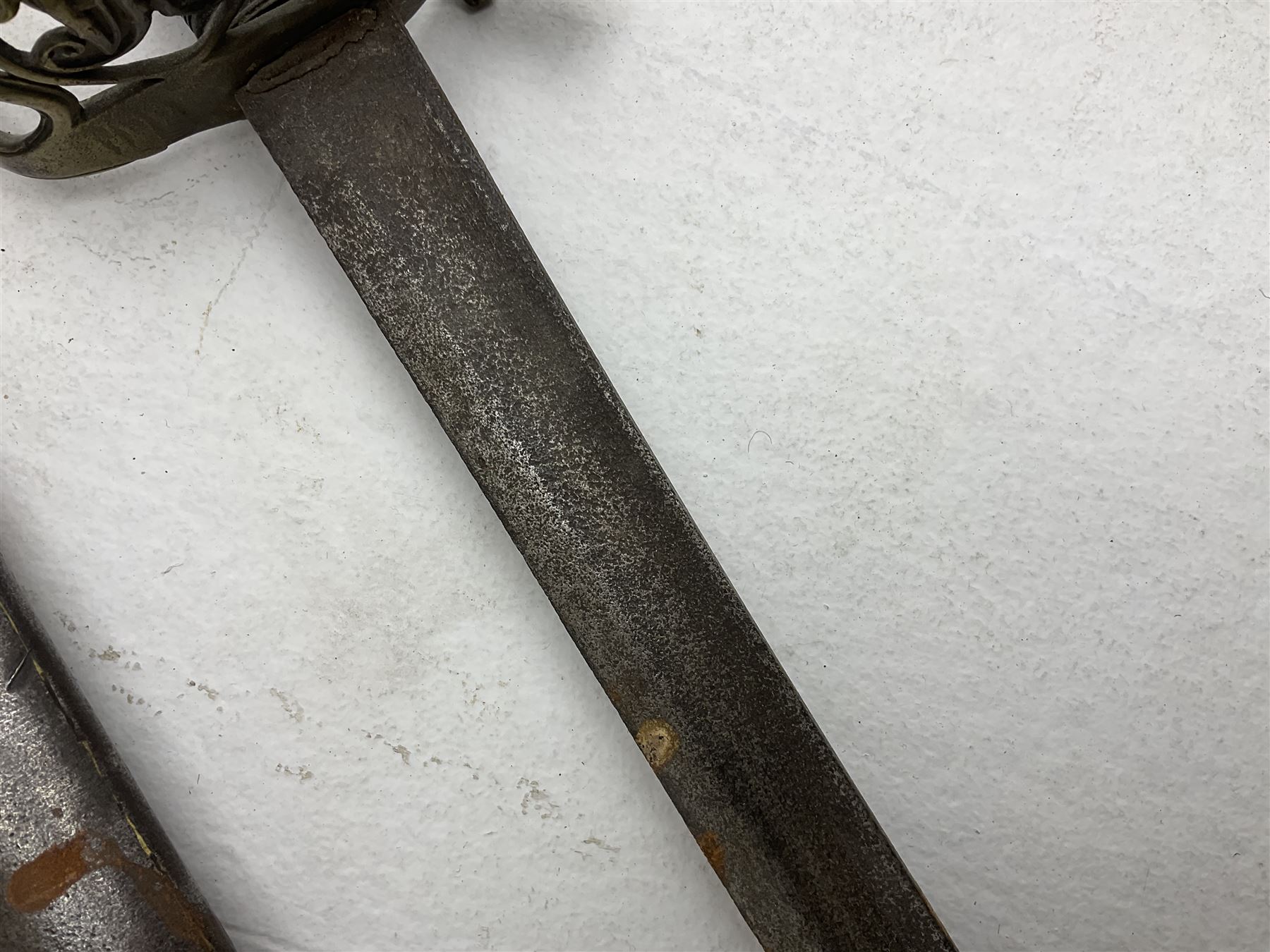 19th century Imperial German army heavy cavalry officers sword by Schnitzler and Kirschbaum, with 89cm single fullered steel blade and sheet steel basket hilt with teardrop cut-out and wire-bound leather grip L107.5cm overall; in steel scabbard with two suspension rings; and British Army 1822 Pattern Infantry Officer's sword in associated scabbard (2)