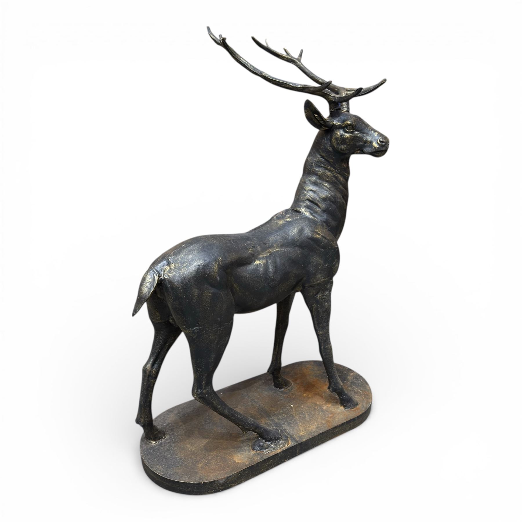 Pair of life-size cast iron garden or home stags, modelled standing upon oval plinths