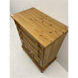 Solid pine chest, fitted with three long drawers and two small panelled cupboards, raised on castors 