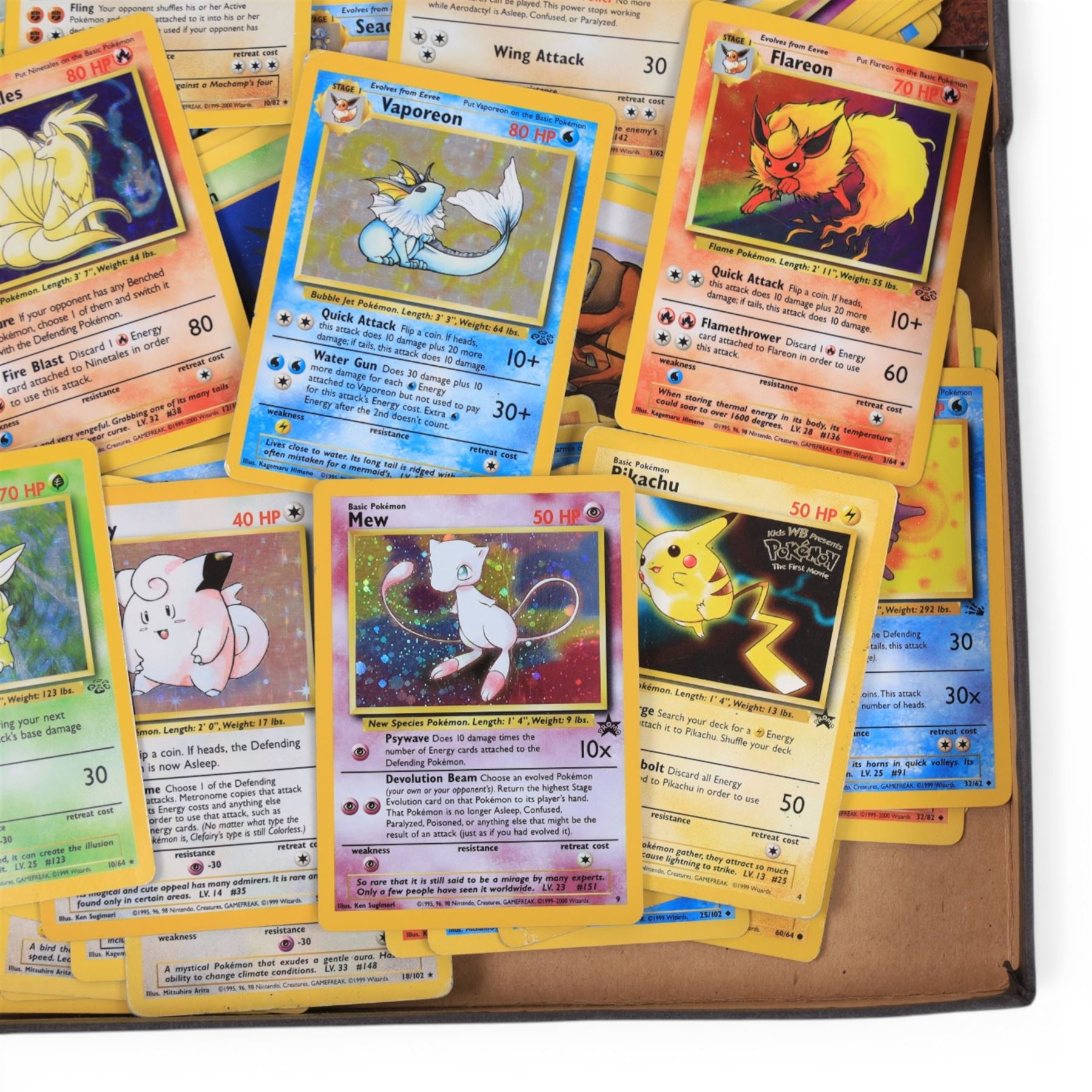 Collection of  Wizards Of The Coast Pokemon trading cards including Base Set, Jungle Set, Fossil Set and Team Rocket examples, black star promo Mew, Arcanine and Pikachu, holo Ninetales and Clefairy, 1st edition pre-release holo Aerodactyl, Team Rocket Dark Machamp holo and Jungle set Flareon, Vaporeon and Scyther holos 