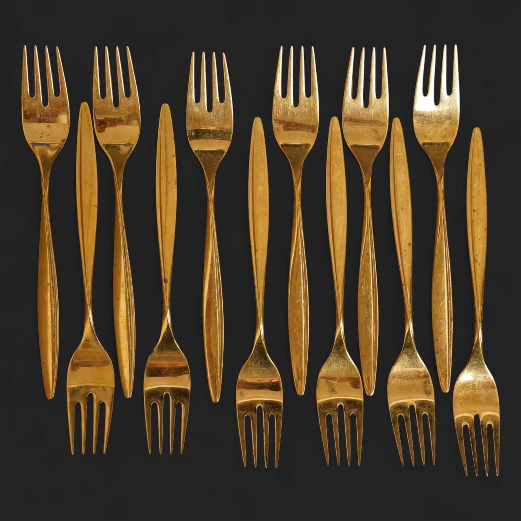 Extensive suite of WMF 800 silver gilt cutlery, for twelve covers, comprising twelve table knives and forks, fish knives and forks, dessert forks, table spoons, dessert spoons, teaspoons, eleven dessert forks and six serving spoons, with crescent moon and crown WMF hallmarks