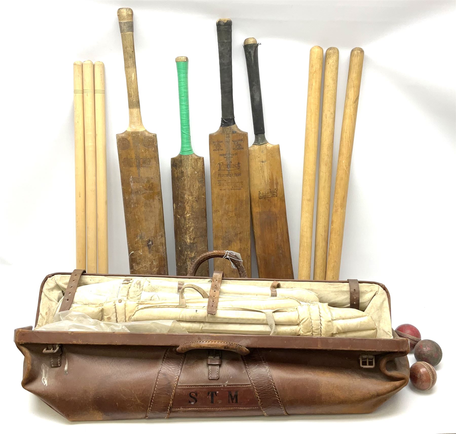 A Vintage leather cricket bag and equipment, to include cricket bats, balls, wickets, and pads. 