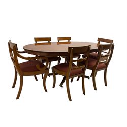 Regency design yew wood dining table, oval cross-banded top with reeded edge, raised on turned pedestal with reeded sabre supports terminating in brass hairy paw feet and castors (W138cm D100cm H75cm); and Rackstraw - set six (4+2) Regency design dining chairs with red drop-in seats (W50cm H86cm)
